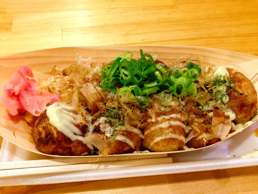 Takoyaki, topped with kewpie mayo, bonito flakes, and scallions